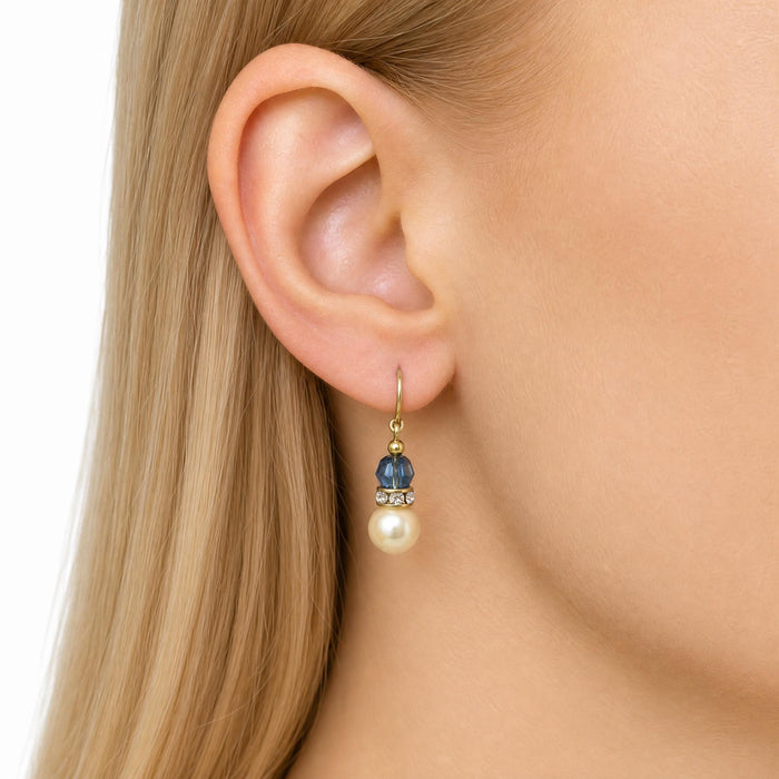 Owen Glass Collection 15-inch pearl crystal drop earrings with indigo blue accents and rhinestone details, hanging gracefully.
