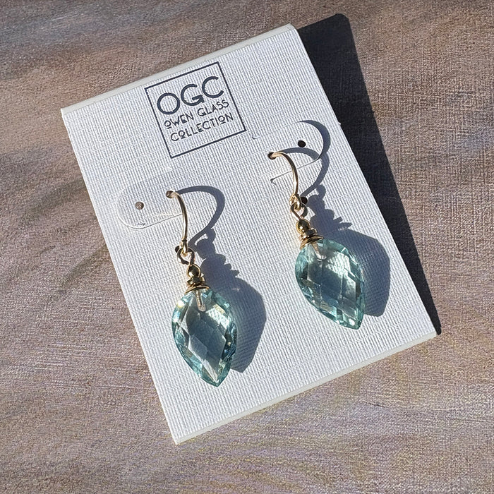 Owen Glass Collection Harlequin 6-inch aqua glass and gold earrings with geometric design, hanging against a neutral background.